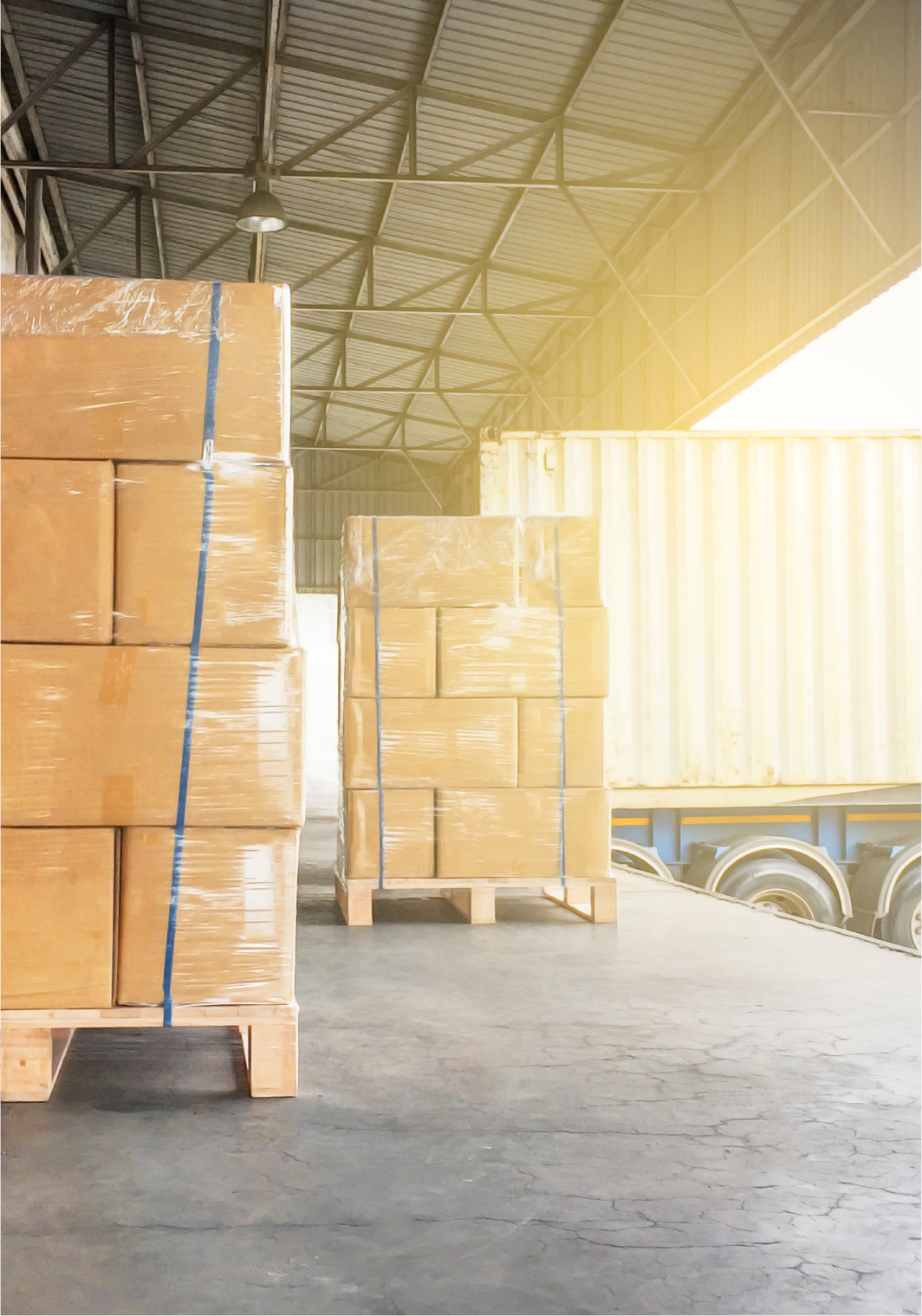 Truck backed up to warehouse floor with pallets